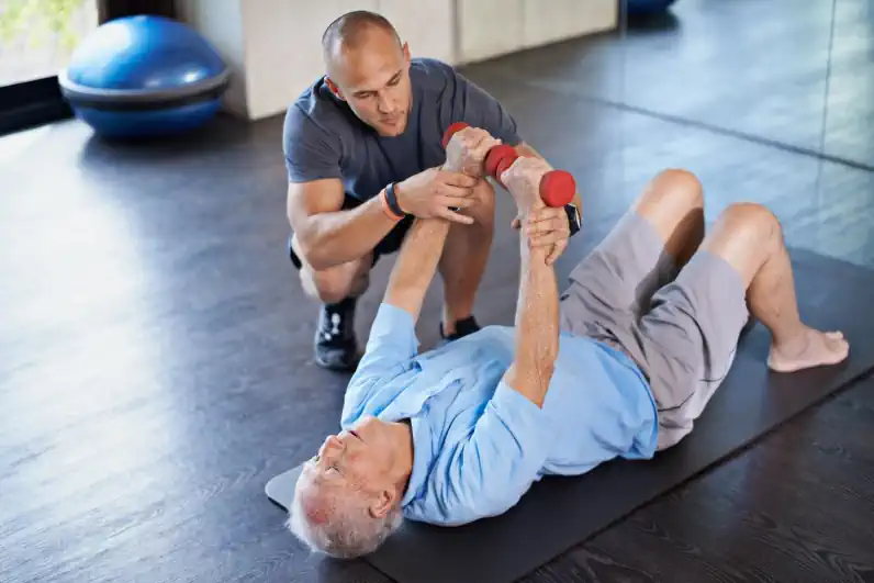 Senior Fitness Specialist Helping a Senior Man